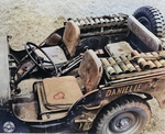 A Jeep packed with mortar shells, a mortar tube between the seats, and the mortar plate on the floor, New Caledonia, 1942.