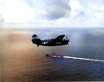 SB2C Helldiver of Bombing Squadron VB-86 approaching the carrier Wasp (Essex-class) near Japan, 1945. Note the white radar pod under the wing.