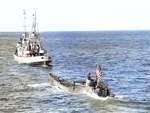 Oceangoing tug USS Abnaki takes the captured Type IXC submarine U-505 under tow, 7 Jun 1944. U-505 was captured three days earlier by the USS Guadalcanal hunter group. Photo 1 of 3.