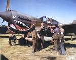 Chinese and American armorers checking the guns on a Curtiss P-40E Warhawk of the 74th Fighter Squadron, 23rd Fighter Group at Kunming, China, 1 Feb 1943