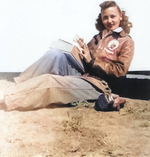 Posed photo of a WASP pilot in flight gear and leather flying jacket showing WASP “Fifinella” patch, 1944, location unknown but probably Avenger Field, Sweetwater, Texas, United States.