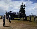 USS Lexington (Essex-class) flight deck personnel spotting one F6F-5 Hellcat that has just landed as next one taxis forward and next one is about to land, all returning from raids on the Ryukyu Islands, 10 Oct 1944