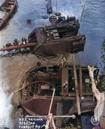 Salvage work continuing on the sunken battleship USS Arizona in Pearl Harbor, Hawaii, 25 Feb 1942. Note Arizona’s two after main turrets being pumped out and disassembled.