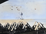 As seen from the USS Essex, the USS Enterprise burns furiously after a Japanese Special Attack aircraft struck the carrier at the forward elevator off Kyushu, Japan, 14 May 1945