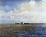 Carrier USS Bunker Hill taking a near miss from a Japanese dive bomber close aboard the starboard quarter, 19 Jun 1944 off Guam, Mariana Islands. The ship was not damaged. Photo 2 of 2