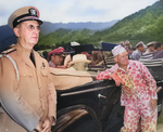 While touring Oahu, US Territory of Hawaii, President Franklin Roosevelt (seated in car) listened to Col William Saffarans (in jungle suit) at the Army’s Jungle Training Unit at Kahana Bay, 28 July 1944. Photo 1 of 2.