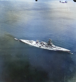 Post-war photo of a TBM-3 Avenger from Torpedo Squadron VT-27 from the aircraft carrier USS Independence flying over the Japanese battleship Nagato at Yokosuka, Japan, Aug-Sep 1945