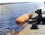 A Mark XIII aerial torpedo being launched from a PT Boat by simply dropping it over the side during tests in the Rendova area of the Solomon Islands, 1943.