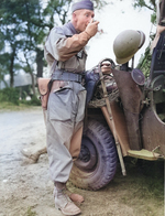 Russian Count Nicolas Roumiantzoff serving as a Lt Colonel with the Free French Division, First Spahis Regiment, takes a meal in the field in France, 1 Aug 1944. Note French helmet and uniform but US equipment otherwise.