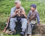 US Army Signal Corps photographer Private Arthur W. Hedgo with Chinese boy Lee Ting Yow, northern Burma, 6 May 1944