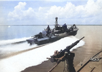 Elco 80-foot torpedo boat PT-130 at cruising speed as seen from PT-143, 1944-45. Note Mark XIII aerial torpedoes, Bofors 40mm gun aft, and 37mm cannon forward on PT-130 and Oerlikon 20mm gun in foreground.