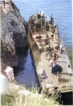 PT-215, a Higgins 78-footer of Motor Torpedo Boat Squadron 15 (MTBRon 15), tied up in Blue Grotto, Capri, Italy in Mar 1944.