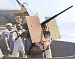 African-American mess attendants take their turn at a 20mm gun during gunnery training on Aircraft Transport USS Copahee during transit from California to Pearl Harbor, 9 Sep 1942. Note TBF Avengers on the flight deck.