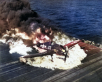 Ensign Ardon R. Ives of Fighting-Bombing Squadron VBF-9 crashed his F6F-5 Hellcat through the barrier on USS Lexington (Essex-class) and ruptured the center-line fuel tank, Feb 1945, western Pacific. Photo 3 of 7