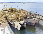 USS LST-646 and USS LST-662 entering the floating drydock USS ABSD-6 in Apra Harbor, Guam, 29 May 1945.