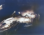 Crews apply water to smoldering fires on the hangar deck of the USS Randolph after a P1Y Ginga special attack bomber crashed into the ship while at anchor in Ulithi Lagoon, Caroline Islands, 11 Mar 1945.