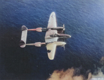 Lt Fred Eberle of the USAAF 333rd Fighter Squadron nursing his damaged P-38 Lighting back to Saipan after receiving battle damage over Iwo Jima, 15 Jan 1945. Photo taken from an accompanying B-24 Liberator.