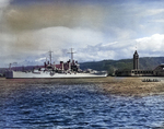 USS Honolulu in Honolulu Harbor, Hawaii, 14 Jul 1939. The Aloha Tower and an outrigger canoe can be seen at right.