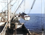 Crewmen of the USS Elmore hoisting LCVPs as part of disembarking United States Army troops of the 19th Infantry Regiment, 3rd Battalion for the beaches at Leyte, Philippines, 20 Oct 1944.