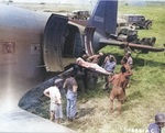 British and American servicemen loading wounded soldiers onto a C-47 Skytrain transport at Agrigento, Sicily for transportation to hospitals in Africa, 25 Jul 1943. Note litter Jeep and WC54 ambulances.