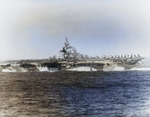 Port side view of USS Ticonderoga with an intentional list to assist firefighting efforts following a kamikaze attack 21 Jan 1945 southeast of Formosa (Taiwan). Photo taken from USS Essex.