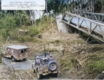 United States Army Engineers construct a “Bailey Bridge” while a WC54 ambulance and a Jeep ford the Mag-Ampon River, San Pablo, Luzon, Philippines, 3 Apr 1945. Note the machine gun mounted in the Jeep.