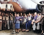 Mary Churchill, daughter of the Prime Minister, holding up a bottle of Coca-Cola just before she cracked it over the machine gun barrels of the B-17G “Stage Door Canteen” as a christening, 21 Apr 1944 at Ridgewell.