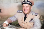 Commodore Dixie Kiefer at his desk at Quonset Point, Rhode Island, United States, 1945. Note the cast on his arm from injuries sustain several months earlier aboard USS Ticonderoga.