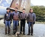 Ground Crewmen with Bombing Squadron 139 posing with their squadron mascot in front of the tail section of a PV-1 Ventura patrol bomber on Attu Island, Alaska, 4 Jun 1944. Note the Marsden mat surface.