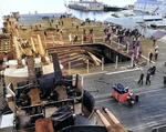 The after-flight deck of the USS Bunker Hill in Puget Sound Naval Shipyard’s Dry Dock No. 5 shortly after arriving at Bremerton, Washington, United States, 16 Jun 1945. Note the collapsed aircraft elevator.