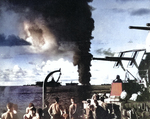 Smoke plume from the burning oiler USS Mississinewa in Ulithi Lagoon as seen from the battleship USS South Dakota, 20 Nov 1944. Carriers in the foreground are Bunker Hill and Langley (Independence-class).