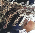 Aerial view of Gotenhafen (Gdynia), occupied Poland, Jun 1942, photo 1 of 2; photo taken by a British RAF aircraft; note battlecruiser Gneisenau (white arrow) and carrier Graf Zeppelin (bottom)