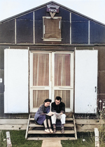 Mr. & Mrs. Hirata on the steps of the YMCA recreation hall at the Manzanar Relocation Center for deported Japanese-Americans, Inyo County, California, United States, 1943.