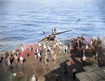 F6F-5 Hellcat BuNo 71632 being “surveyed” over the side of USS Hancock after flipping onto its back from a barrier crash on landing following a strike against Iwo Jima, 21 Feb 1945. The pilot was not hurt.