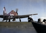 F6F-5 Hellcat with Fighting Squadron VF-82 preparing for a catapult launch from USS Bennington in the Western Pacific, Feb 1945. Note the arrowhead geometrics that identify the plane as coming from the Bennington.