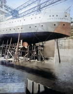 Screws and stern of the cruiser Northampton on the ways ten days before her launching, Bethlehem Steel Fore River Shipyard in Quincy, Massachusetts, United States, 26 Aug 1929. Note the man standing on the scaffold next to the propeller shaft.