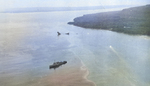 Minelayer USS Breese standing by as a motor launch tows the wreck of the destroyer USS Tucker toward shallow water off Malo Island after Tucker was nearly blown in two by a mine the day before, 4 Aug 1942.