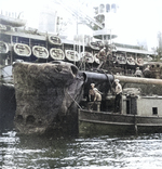 Inspection of USS Growler’s damaged bow while nested alongside sub-tender USS Fulton at Capricorn Wharf, New Farm Submarine Base, Brisbane, Queensland, Australia, 17 Feb 1943.