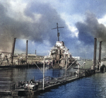 Destroyer USS Shaw with her bow blown off and settled in the sunken floating drydock YFD-2 in Pearl Harbor, Hawaii, mid-Dec 1941. Photo 1 of 2.