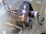 Vought F4U-1D Corsair of Marine Fighting Squadron VMF-451 ‘Blue Devils’ with its wings folded aboard USS Bunker Hill, south of Japan, spring 1945. Note the armorers readying the HVAR rockets and the rocket rack at right