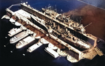 Cruiser USS Nashville in floating drydock ABSD-1 at Espiritu Santo, New Hebrides late Jun 1944. Nashville was having hull damage repaired after a close bomb near-miss in the Bismarck Sea on 4 Jun 1944.