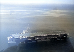 Escort Carrier USS Card in the North Atlantic photographed 10 Aug 1943 amid the large oil slick left by German submarine U-664, sunk by Card aircraft the day before.