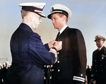 On the flight deck of USS Card, Admiral Royal E. Ingersoll, Commander-in-Chief Atlantic Fleet, awarding the Navy Cross to Lieutenant Charles Hutchins, Captain of USS Borie, for actions against German U-405.