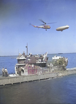 German submarine U-858, the first to be boarded by US forces after Germany’s surrender, arriving at the Delaware Capes, Delaware, United States, 14 May 1945. Note Sikorsky HNS-I Helicopter and K-class airship.