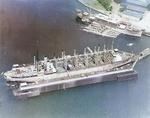 USS Jason (center) at Dewey Drydock, Subic Bay Navy Yard, Olongapo, Philippine Islands, 9 Mar 1932; note USS Canopus at upper right with S-38 (outboard) and three other submarines