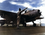 Aboard San Jacinto, Lieutenant Commander Albert B. Cahn gave signal to a VT-51 TBM-1C Avenger to take off for an exercise, 16 May 1944