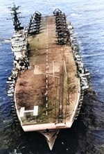 Arromanches underway off French Indochina in the Gulf of Tonkin, Jan 1954; note F6F-5 Hellcat and SB2C-5 Helldiver aircraft on the flight deck