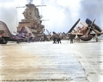 Crewmen of USS Oriskany clearing snow and ice off the flight deck, off Korea, 10 Jan 1953; note F4U-5N Corsair and AD-3W Skyraider aircraft