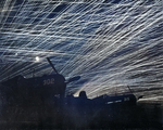 Anti-aircraft tracers in the night sky above Yontan Airfield, Okinawa, Japan, 28 Apr 1945; note US Marine Corps Corsair fighters in foreground