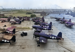 F4U-1 Corsair, FM-2 Wildcat, SNC-1 Falcon, and Culver TD2C aircraft at Naval Air Station Long Beach, California, United States, 10 Aug 1944; note SB2C Helldiver aircraft in background behind pile